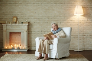 senior woman sitting in a white recliner senior woman sitting in a white recliner